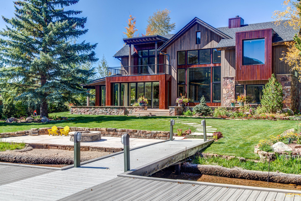 Photo of a large country exterior in Denver with mixed siding.