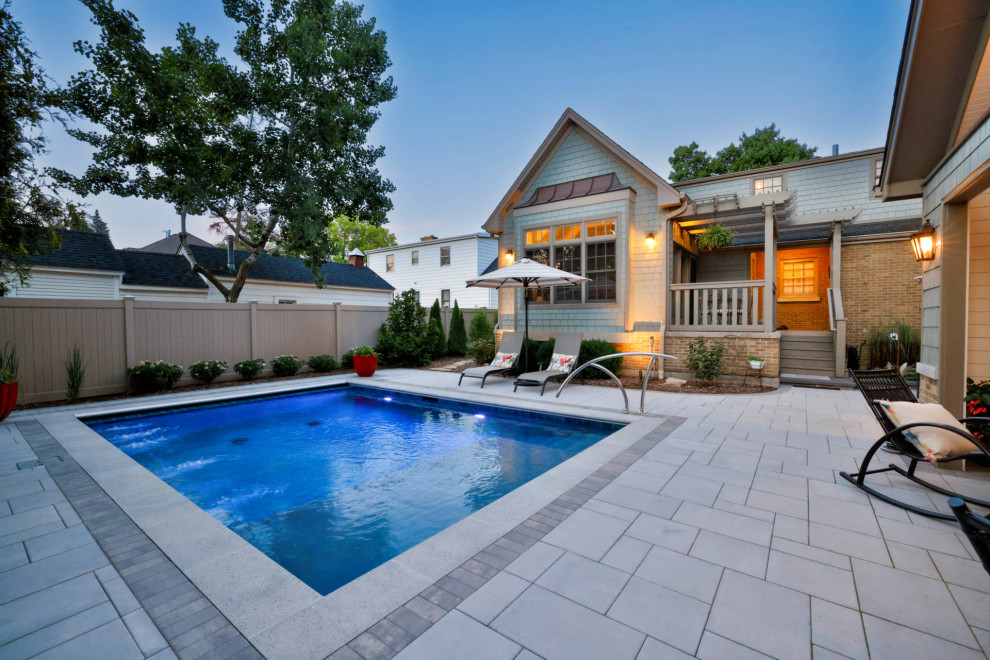 Example of a small classic backyard stone and rectangular pool house design in Chicago