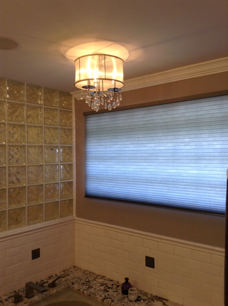 Inspiration for a mid-sized transitional master white tile and subway tile pebble tile floor home design remodel in Seattle with granite countertops, an undermount tub and gray walls