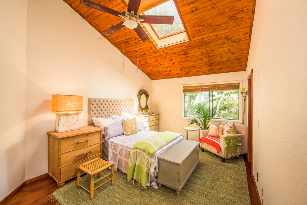 Inspiration for a tropical bedroom in Los Angeles with beige walls and dark hardwood floors.