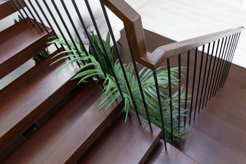 Inspiration for a mid-sized midcentury wood floating staircase in Auckland with open risers and mixed railing.