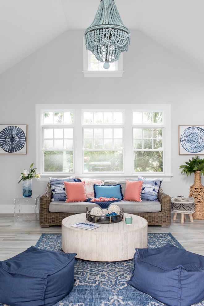 Inspiration for a beach style family room in New York with grey walls and grey floor.