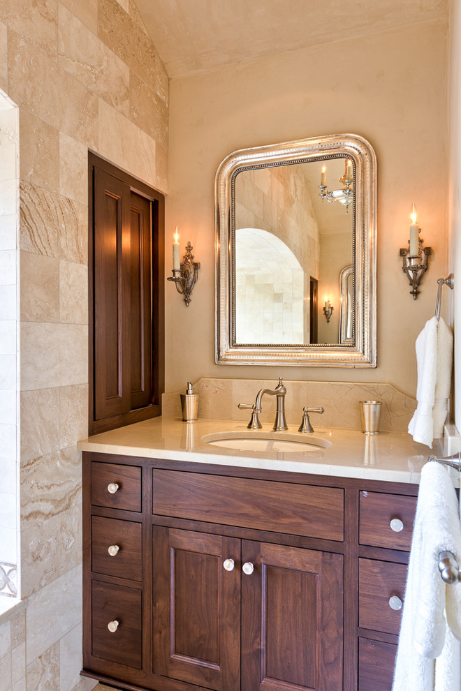 Photo of a large mediterranean bathroom in Other with a drop-in tub, shaker cabinets, dark wood cabinets and an undermount sink.