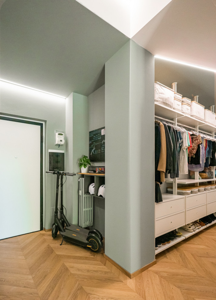 Photo of a small industrial vestibule in Milan with green walls, light hardwood floors, a single front door, a white front door and recessed.