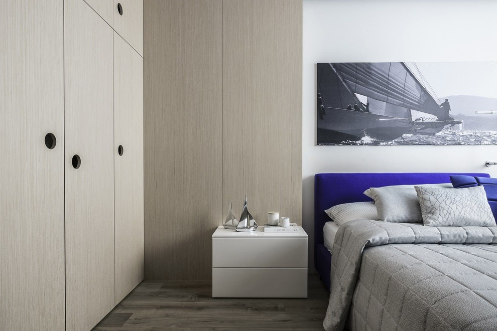 Photo of a contemporary bedroom in Melbourne with white walls and light hardwood floors.