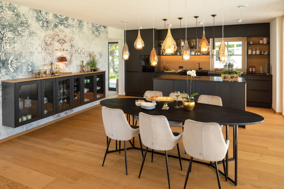 This is an example of a mid-sized country kitchen in Munich with light hardwood floors and with island.