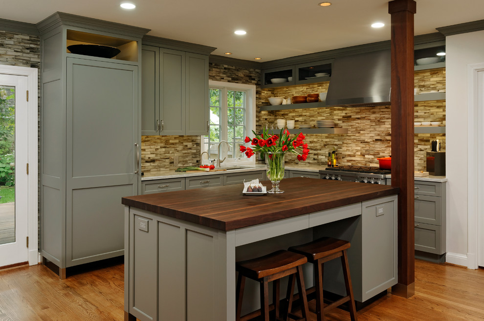 This is an example of a large transitional l-shaped kitchen in DC Metro with shaker cabinets, grey cabinets, ceramic splashback, panelled appliances, medium hardwood floors, with island, brown splashback, an undermount sink and wood benchtops.