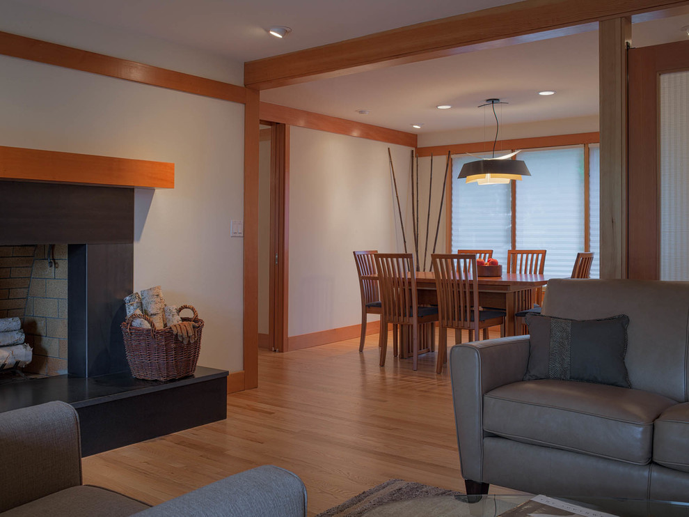 Example of a mid-sized transitional light wood floor great room design in Seattle with white walls, a standard fireplace and a tile fireplace