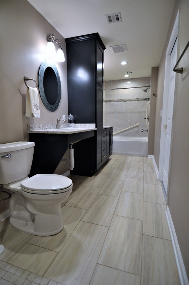 Large transitional master bathroom in Milwaukee with recessed-panel cabinets, black cabinets, an alcove tub, an alcove shower, a two-piece toilet, gray tile, stone tile, beige walls, laminate floors, a wall-mount sink, laminate benchtops, beige floor and an open shower.