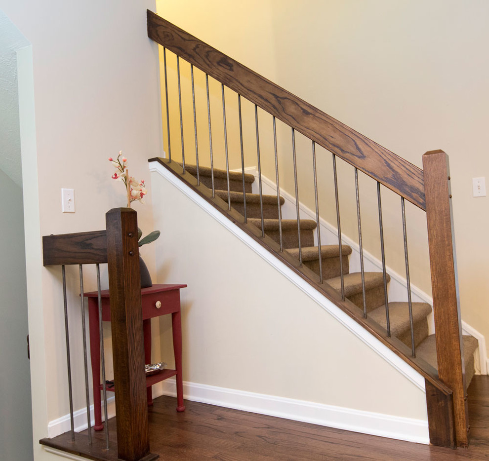 Design ideas for a mid-sized transitional carpeted l-shaped staircase in Cleveland with carpet risers and wood railing.