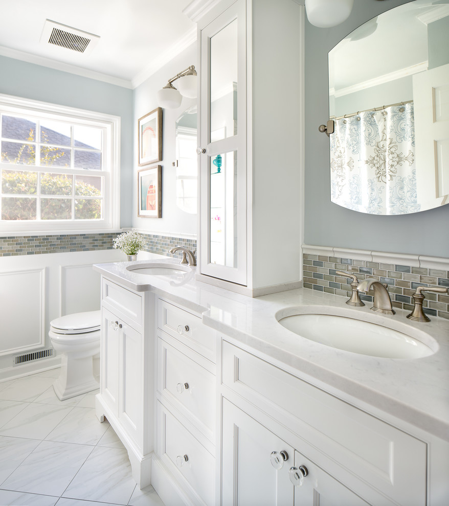 This is an example of a small transitional bathroom in Charlotte with an undermount sink, white cabinets, engineered quartz benchtops, an alcove tub, a shower/bathtub combo, a two-piece toilet, white tile, porcelain tile, grey walls, porcelain floors, recessed-panel cabinets, white floor and a shower curtain.