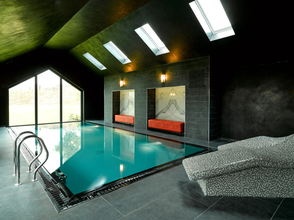 This is an example of a mid-sized contemporary indoor rectangular pool in Other with a pool house and tile.