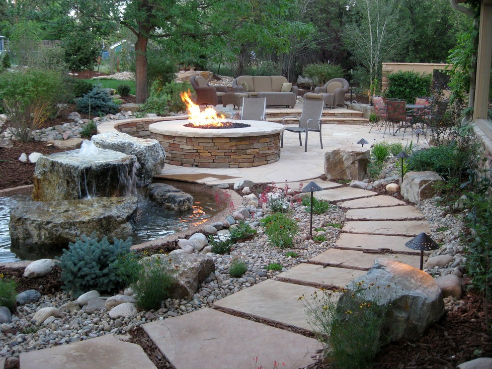 This is an example of a traditional patio in Denver with a water feature.