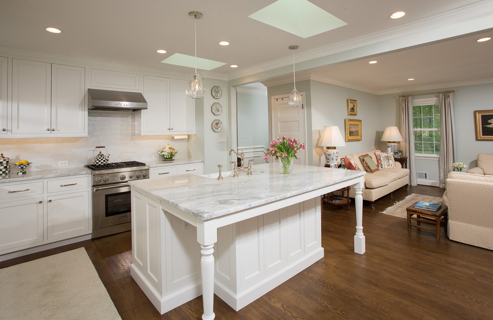 Inspiration for a traditional l-shaped open plan kitchen in DC Metro with a farmhouse sink, recessed-panel cabinets, white cabinets, marble benchtops, white splashback, with island and grey benchtop.