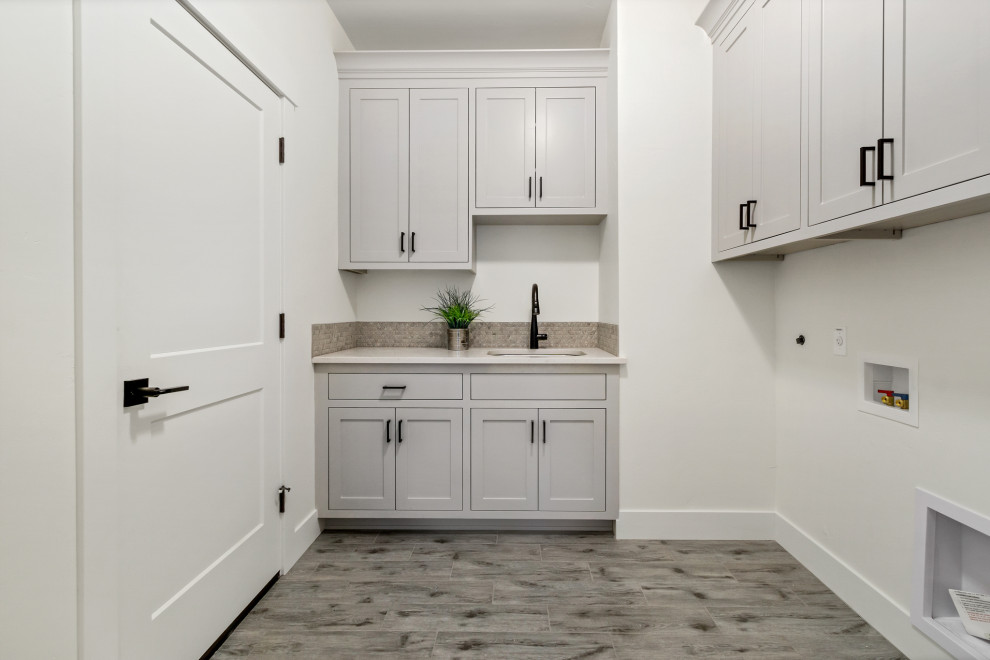 Inspiration for a small traditional l-shaped dedicated laundry room in Portland with an undermount sink, recessed-panel cabinets, grey cabinets, quartz benchtops, white walls, a side-by-side washer and dryer, multi-coloured floor and white benchtop.