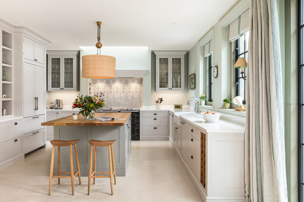 Design ideas for a large traditional u-shaped eat-in kitchen in London with shaker cabinets, grey cabinets, quartzite benchtops, multi-coloured splashback, porcelain splashback, limestone floors, with island, beige floor, white benchtop, a farmhouse sink and panelled appliances.