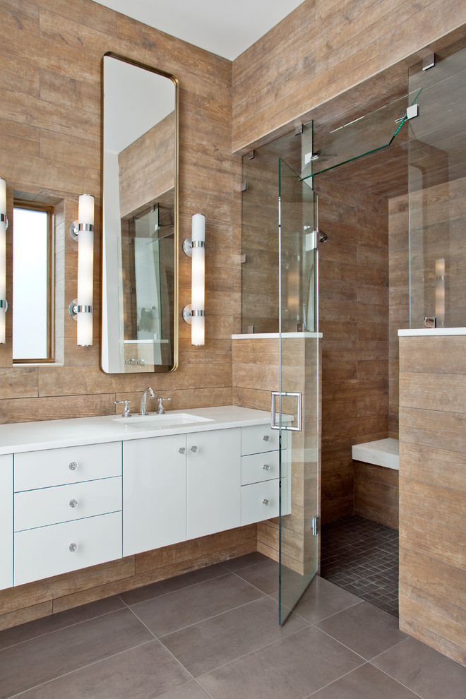 Contemporary bathroom in Other with flat-panel cabinets, white cabinets, an alcove shower, an undermount sink and a hinged shower door.