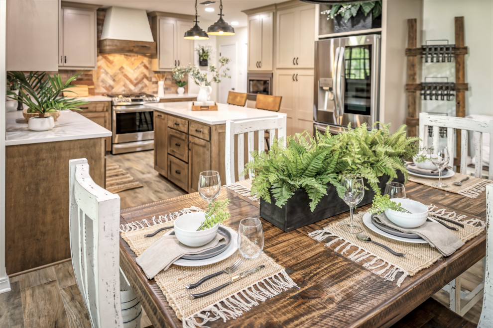 Inspiration for a mid-sized country u-shaped eat-in kitchen in Other with an undermount sink, shaker cabinets, medium wood cabinets, quartzite benchtops, multi-coloured splashback, porcelain splashback, stainless steel appliances, porcelain floors, with island, brown floor and white benchtop.