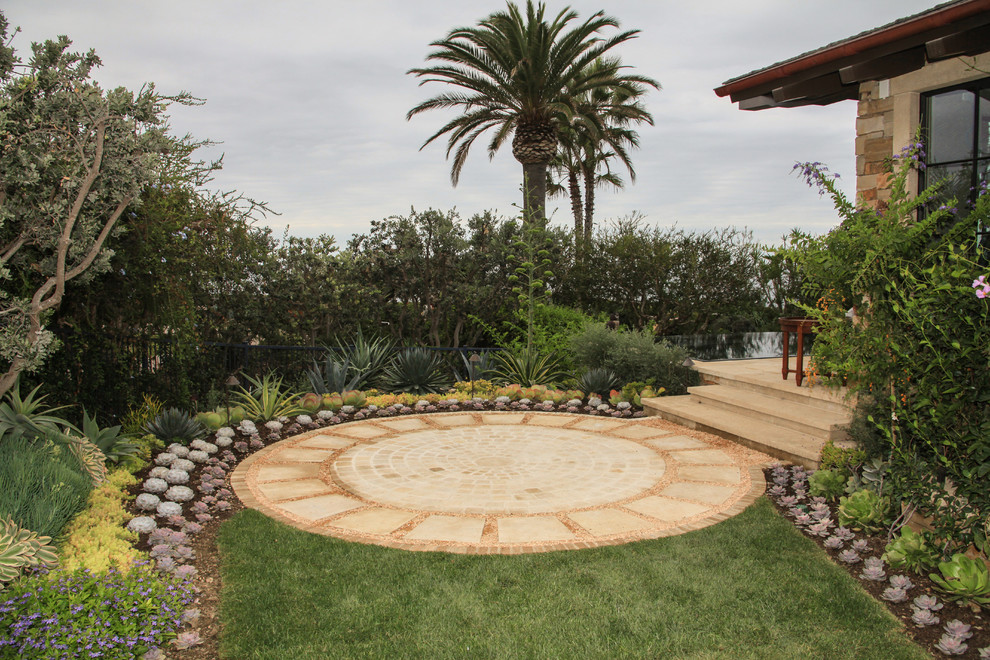 Design ideas for a mediterranean garden in Orange County with a water feature.