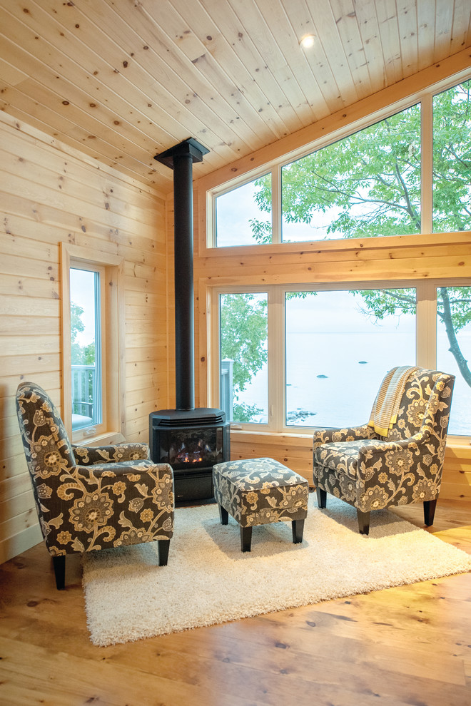 Inspiration for a mid-sized beach style open concept living room with medium hardwood floors and a wood stove.