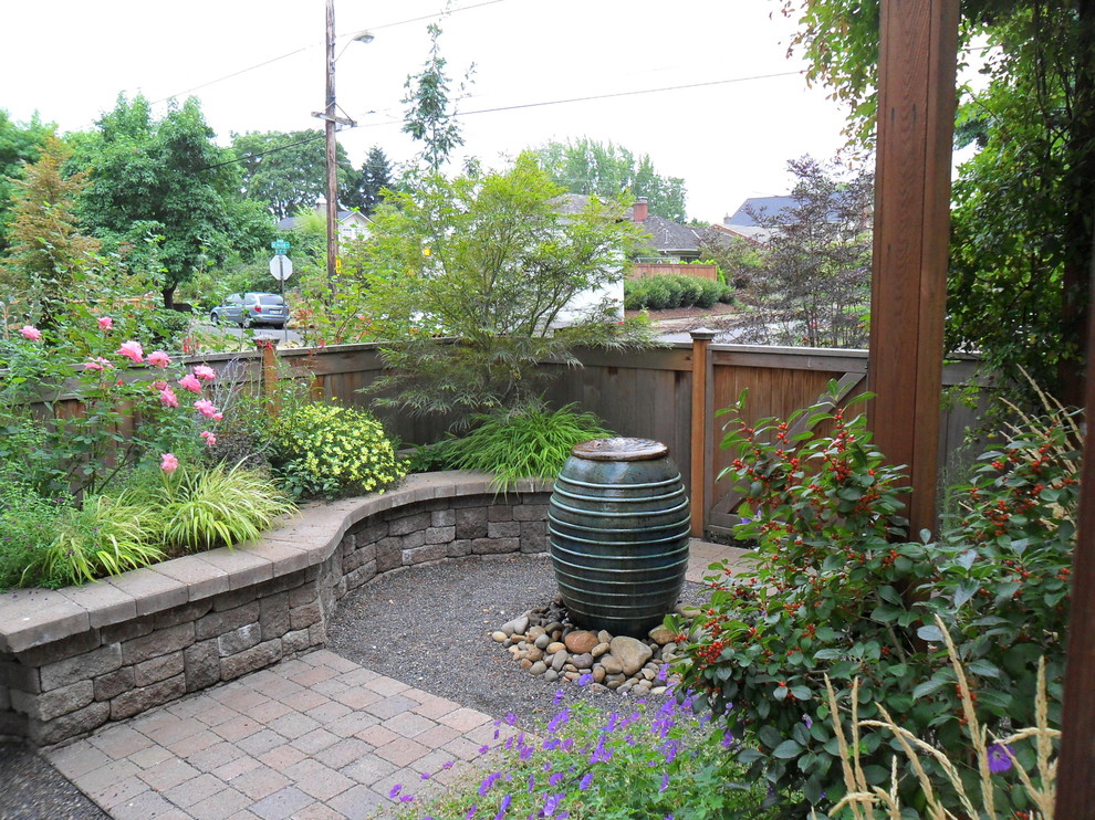 Photo of a traditional courtyard garden in Portland with a water feature.