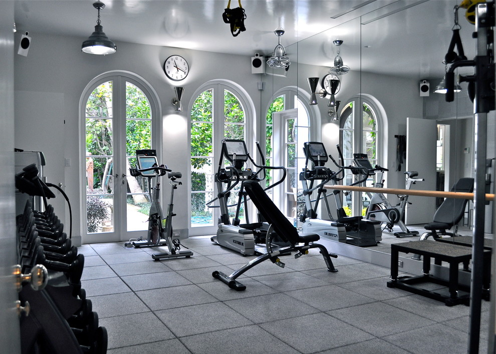 This is an example of a large modern multipurpose gym in Other with white walls and vinyl floors.