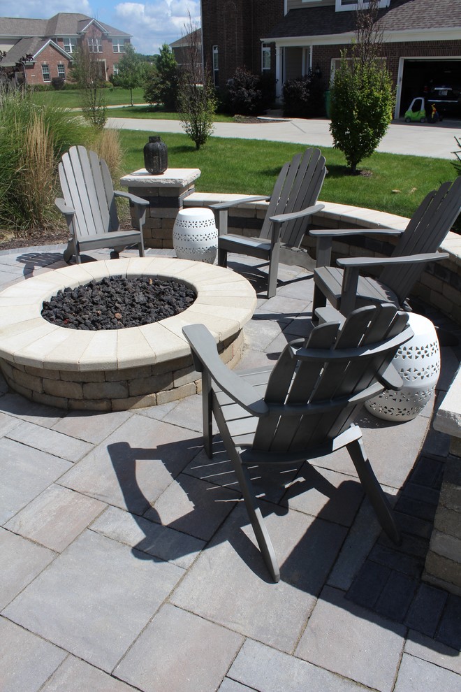 Photo of a small traditional backyard patio in Indianapolis with a fire feature, brick pavers and no cover.