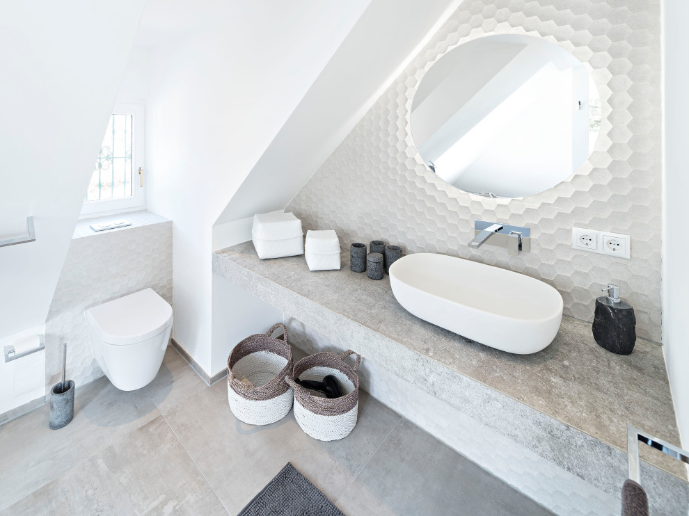 This is an example of a small contemporary bathroom in Munich with a curbless shower, a wall-mount toilet, beige tile, beige walls, ceramic floors, a vessel sink, concrete benchtops, a hinged shower door, grey benchtops, a shower seat, a single vanity and a built-in vanity.