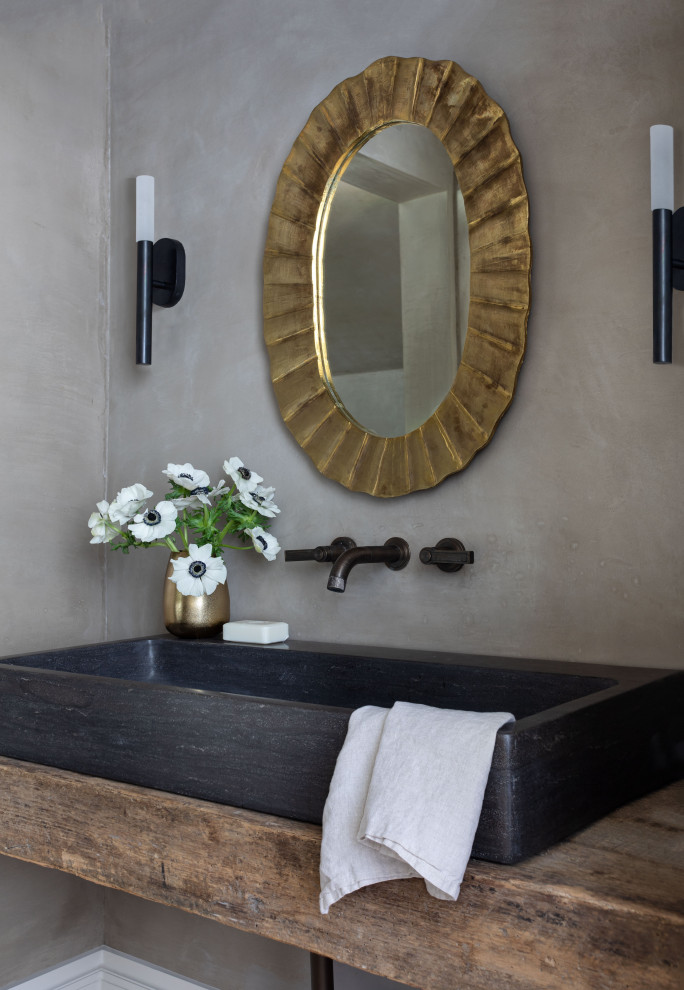 Mid-sized transitional powder room in Houston with recessed-panel cabinets, grey cabinets, black walls, a trough sink, marble benchtops, black benchtops and a built-in vanity.