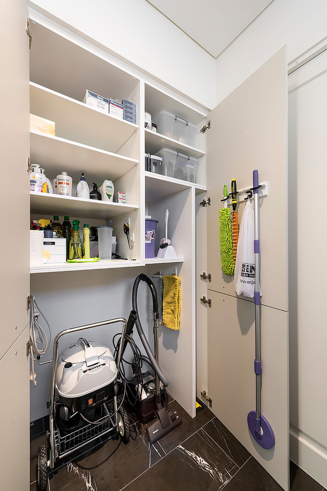 This is an example of a large contemporary galley separated utility room in Perth with a single-bowl sink, flat-panel cabinets, white cabinets, engineered stone countertops, white splashback, glass sheet splashback, white walls, marble flooring, a side by side washer and dryer, grey floors and white worktops.