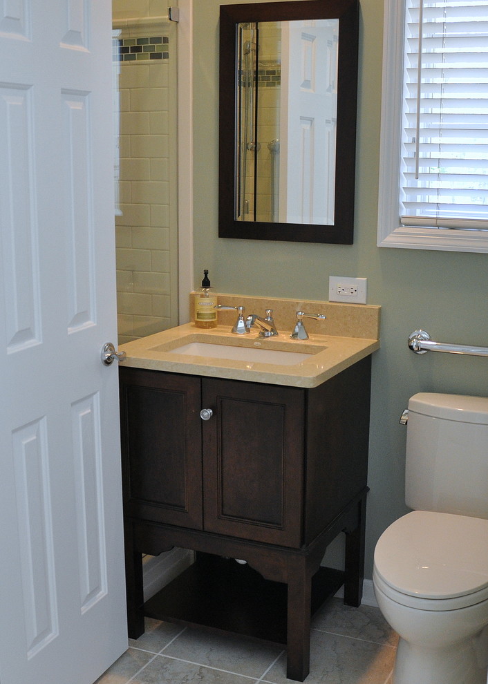 This is an example of a small transitional 3/4 bathroom in Chicago with an undermount sink, furniture-like cabinets, engineered quartz benchtops, dark wood cabinets, an alcove shower, a two-piece toilet, white tile, subway tile, green walls and travertine floors.