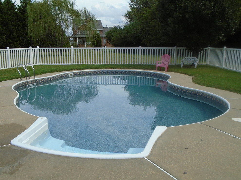 Example of a mid-sized trendy backyard concrete paver pool design