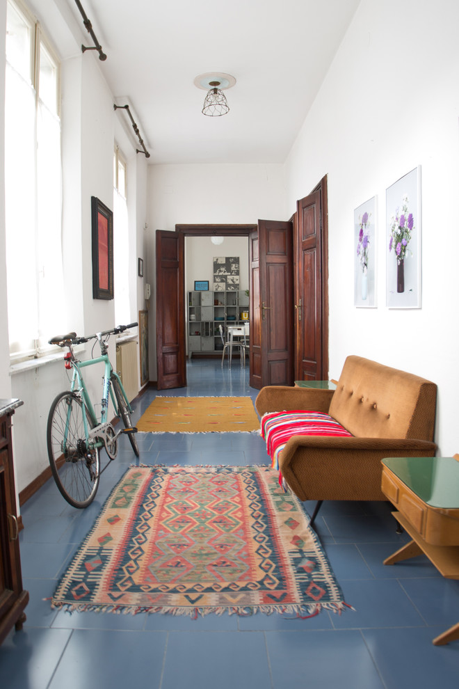 Photo of a large eclectic hallway in Other with white walls, ceramic floors and blue floor.