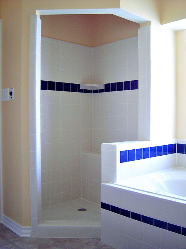 Transitional alcove bathtub photo in Austin with yellow walls