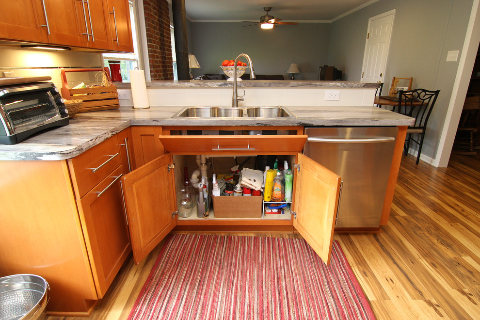 Inspiration for a large transitional u-shaped medium tone wood floor eat-in kitchen remodel with a drop-in sink, recessed-panel cabinets, medium tone wood cabinets, laminate countertops, white backsplash, ceramic backsplash, stainless steel appliances and a peninsula