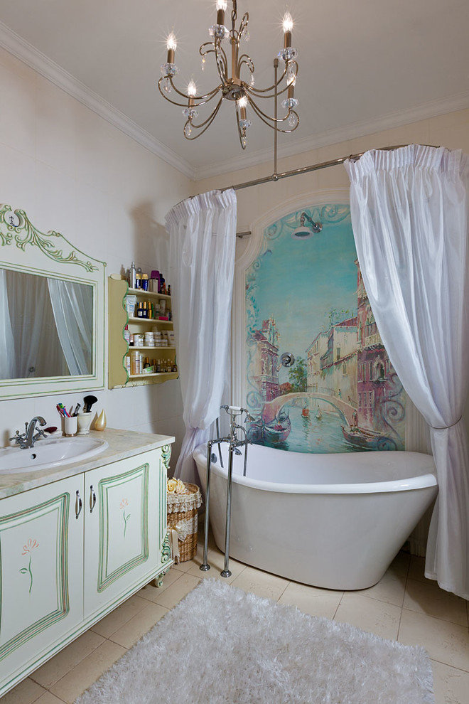 This is an example of a mid-sized traditional master bathroom in Other with a drop-in sink, a freestanding tub, a one-piece toilet, beige tile, ceramic tile, beige walls and ceramic floors.