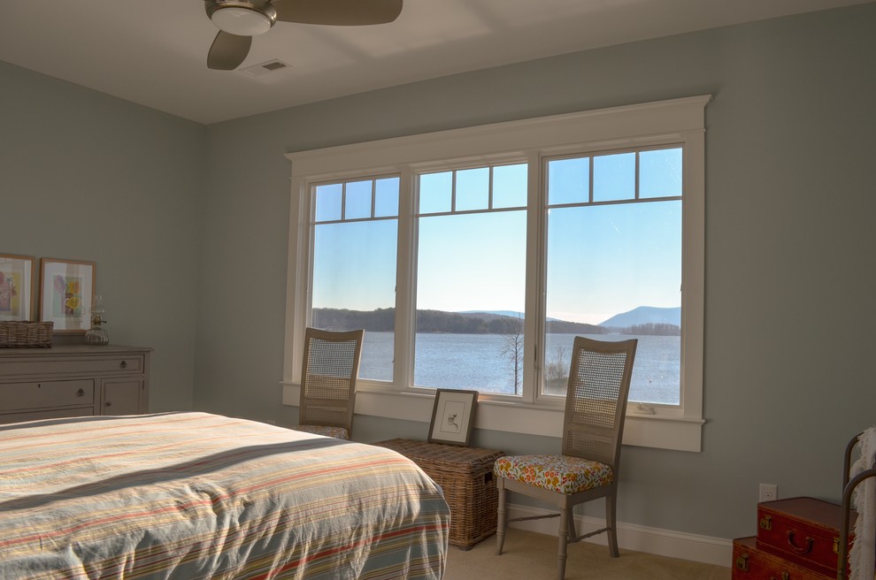 This is an example of a beach style guest bedroom in Other with grey walls.