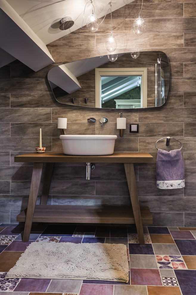This is an example of a small eclectic bathroom in Moscow with open cabinets, multi-coloured tile, brown walls, a vessel sink, wood benchtops, dark wood cabinets and multi-coloured floor.