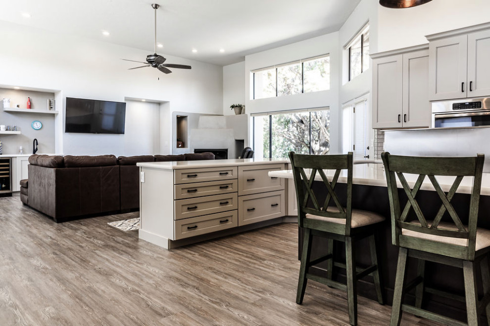 Eat-in kitchen - large transitional u-shaped vinyl floor and gray floor eat-in kitchen idea with an undermount sink, shaker cabinets, gray cabinets, quartzite countertops, green backsplash, subway tile backsplash, stainless steel appliances, an island and white countertops