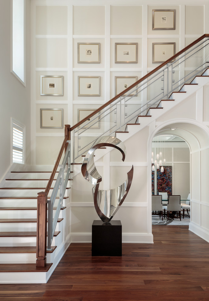 Design ideas for a large transitional wood l-shaped staircase in Miami with mixed railing and painted wood risers.