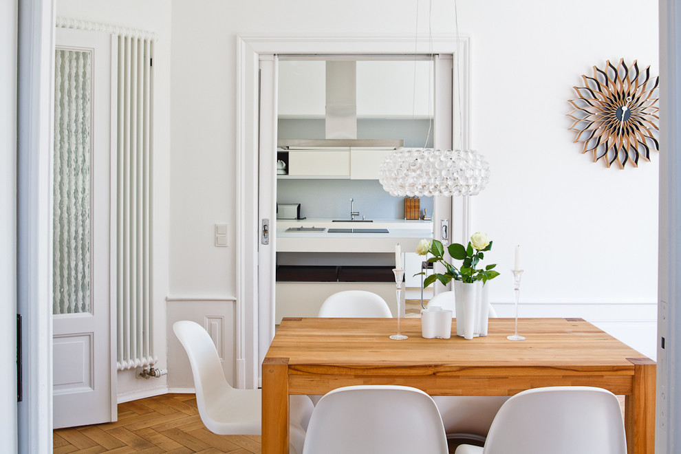 Design ideas for a scandinavian dining room in Frankfurt with white walls and medium hardwood floors.