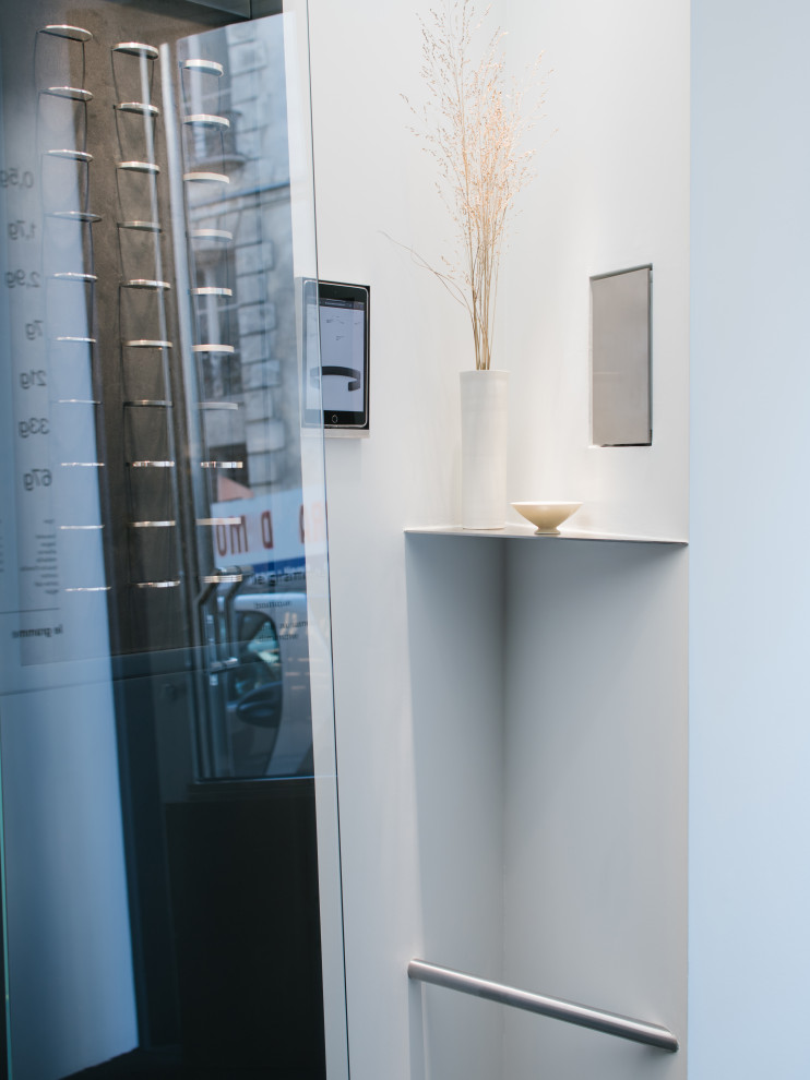 This is an example of a small contemporary entryway in Paris with grey walls.
