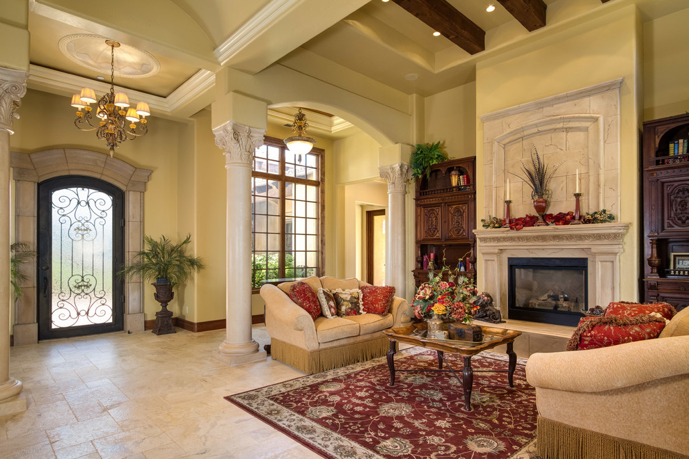 This is an example of an expansive mediterranean formal open concept living room in Orange County with beige walls, marble floors, a standard fireplace, a concrete fireplace surround and no tv.