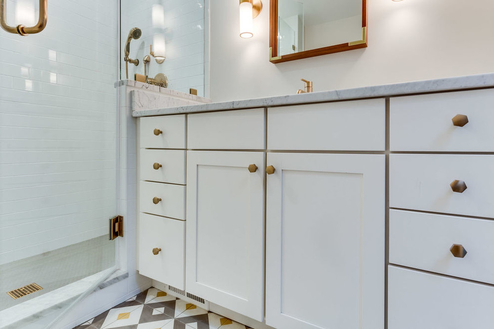 Inspiration for a transitional white tile and cement tile cement tile floor alcove shower remodel in DC Metro with an undermount sink, marble countertops and white countertops