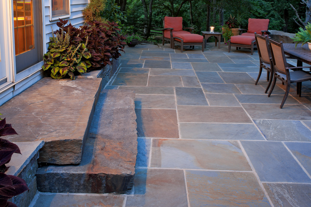 Design ideas for a contemporary backyard patio in Baltimore with natural stone pavers.