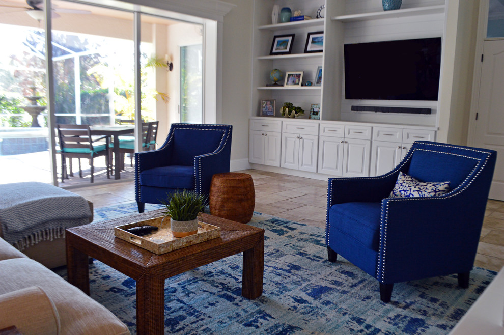 Mid-sized beach style open concept family room in Orlando with blue walls, ceramic floors, a built-in media wall and beige floor.