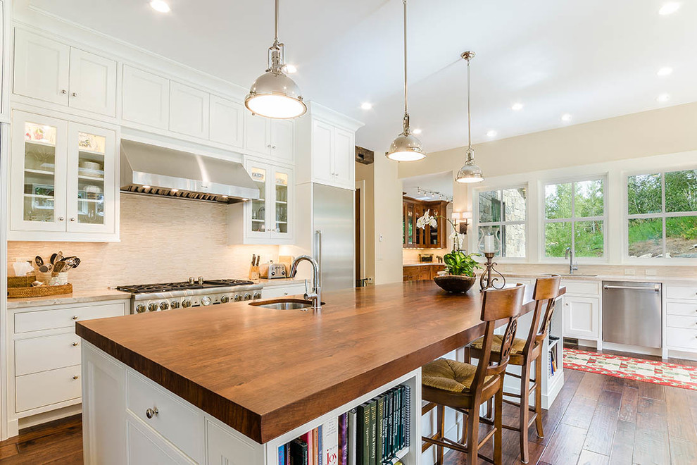 Eat-in kitchen - huge transitional l-shaped dark wood floor and brown floor eat-in kitchen idea with an undermount sink, shaker cabinets, white cabinets, wood countertops, gray backsplash, matchstick tile backsplash, stainless steel appliances and an island
