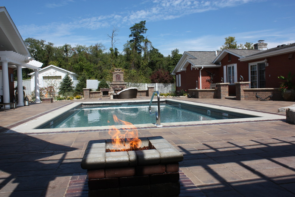 Inspiration for a mid-sized transitional backyard concrete paver and rectangular lap pool remodel