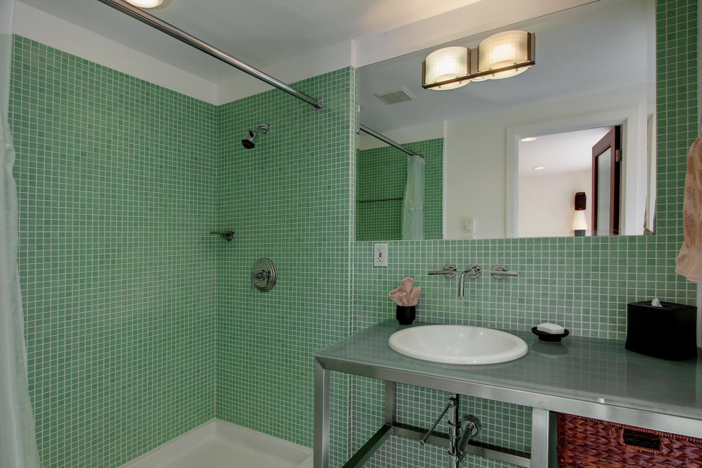 Photo of a midcentury bathroom in Seattle with a drop-in sink, open cabinets, stainless steel benchtops, an open shower, green tile and white walls.