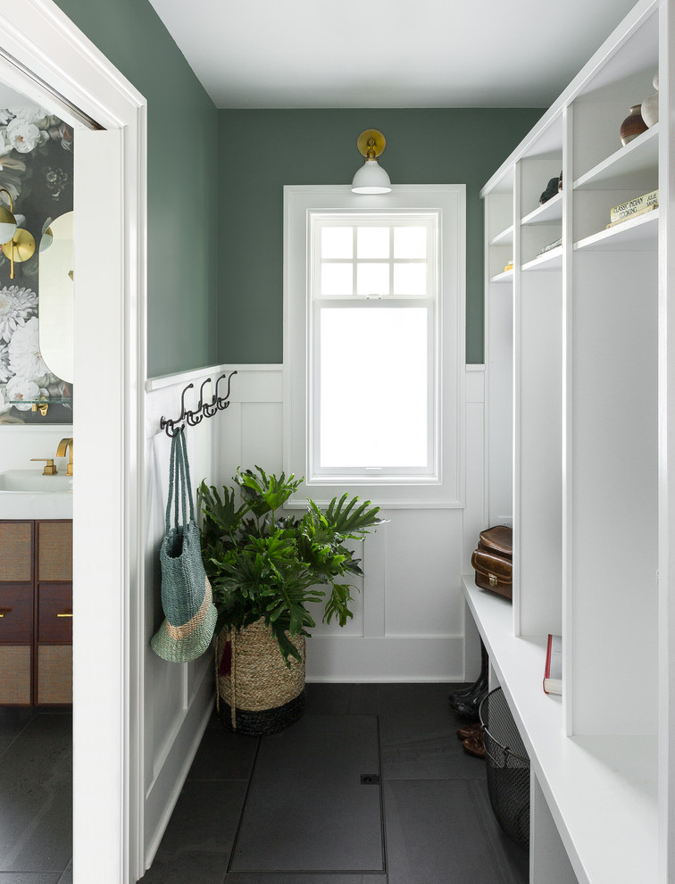 Inspiration for a transitional mudroom in Seattle with green walls and black floor.